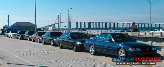 Blue 1997 Ford Crown Victoria in a line of sedans on a bridge