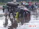 2005 Dodge 1500 - Monster truck overturned in water with spectators watching. Date stamp shows 2007.