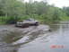 2005 Dodge 1500 - Pickup truck navigates a muddy water crossing, kicking up water. Date stamp indicates 2007.