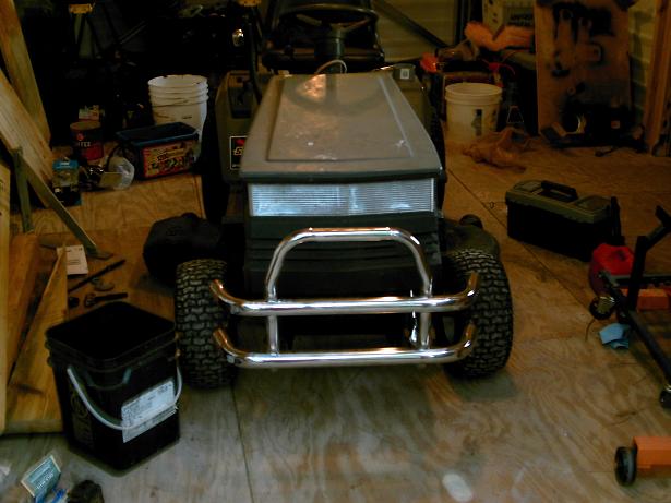 Front view of a lawn tractor with a chrome bull bar and horizontal grille