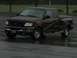 1998 Ford F-150 - A dark brown Ford F-150 pickup truck is parked on a wet surface.
