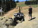 1979 Ford Bronco - Off-road vehicle tackling a challenging rocky obstacle on a sunny day.