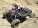 1979 Ford Bronco - Custom rock crawler buggy with two occupants navigating challenging sandy terrain.