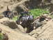 1979 Ford Bronco - A heavily modified off-road vehicle is shown traversing a challenging rocky landscape.