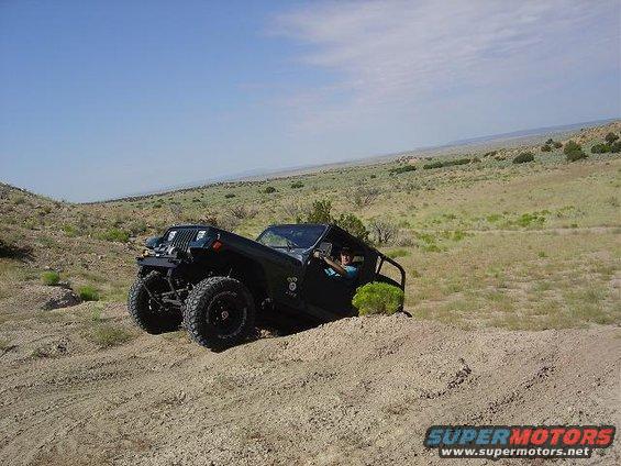 Black off-road vehicle on a dirt hill