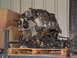 1994 Jeep YJ - Engine assembly with wiring harness and pulleys, resting on a wooden pallet.