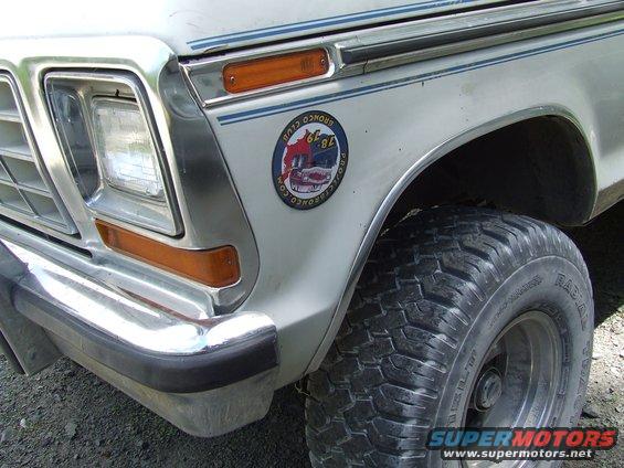 Close-up of a '78 Bronco Club sticker on a vehicle fender. The sticker shows two Broncos and text