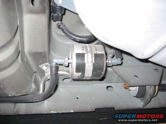 fuel filter. positioned right side in front of spare tire well