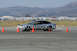 1993 Ford Probe - A silver coupe is seen on an asphalt track, maneuvering around orange cones during a timed event.