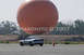 1993 Ford Probe - A silver coupe is seen on a paved surface with a large orange sphere dominating the sky behind it.