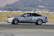 1993 Ford Probe - A silver coupe is seen in profile on a race track, with racing numbers visible on its side.