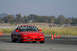 1993 Ford Probe - A red sports coupe navigates a course marked by orange cones on a sunny day.