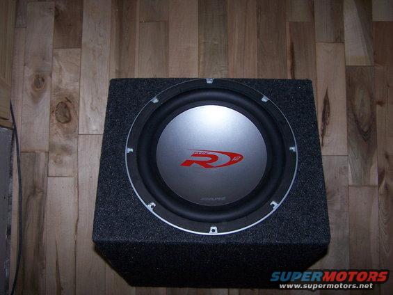 Alpine R-Series 12-inch subwoofer in a carpeted enclosure