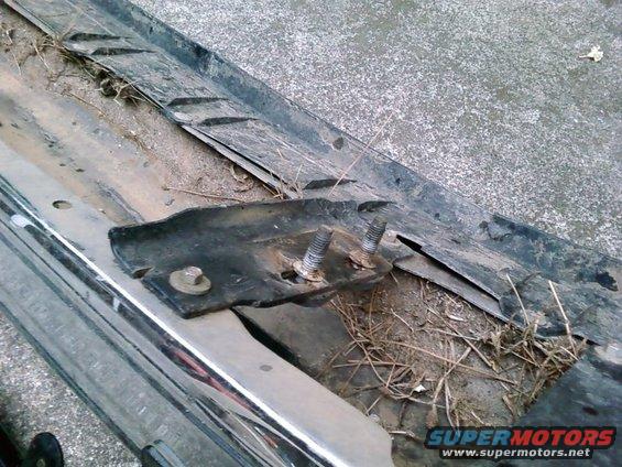 Chrome bumper section with rusted mounting bracket and bolts