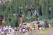 1978 Ford Bronco - A mountain biker performs an aerial stunt over a dirt ramp, with spectators watching and trees in the background.