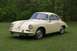 1965 Porsche 911 - This classic Porsche 356 is shown from the front-right angle, parked outdoors on a grassy lawn.