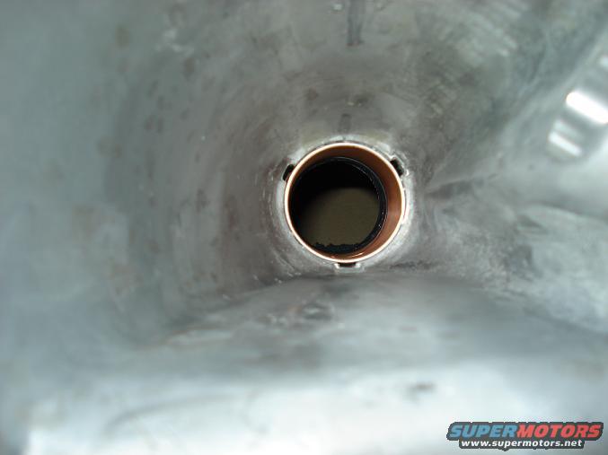 Interior of a transmission tailshaft housing with a bronze bushing visible in the center