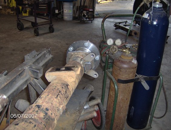 rear axle assembly with welding torch and oxygen tanks nearby