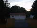 2004 Ford Crown Victoria - A suburban scene depicts a detached garage with two white doors under a dusky sky.
