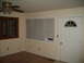 2004 Ford Crown Victoria - This is an interior scene of a room, a ceiling fan, a window with blinds, and a white door with a decorative glass panel.