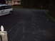 2004 Ford Crown Victoria - A white van with company branding is parked on an asphalt driveway in front of a house.