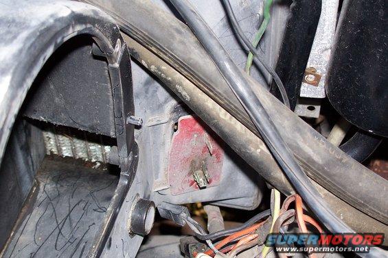 Close-up of automotive wiring, hoses, and ducting, possibly from an engine bay or dashboard