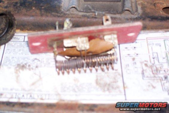 Close-up of a blower motor resistor with visible corrosion on the coils