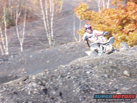 ATV with rider on a dirt hill
