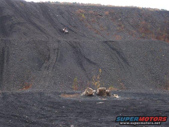ATV on a steep coal pile