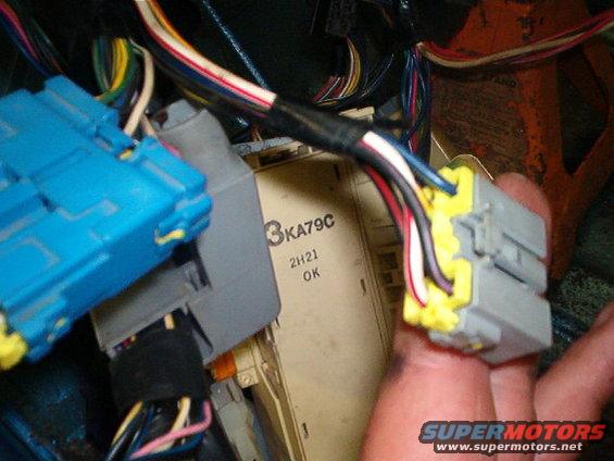 Close-up of blue and yellow electrical connectors with wiring harness