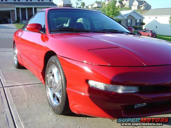 Red 1997 Ford Probe parked on a driveway, front quarter view
