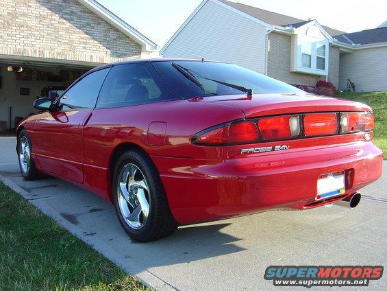 Red 1997 Ford Probe 24V parked on a driveway, rear 3/4 view