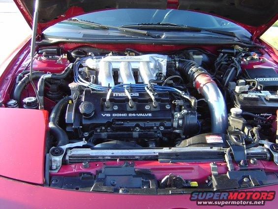Mazda V6 DOHC 24-valve engine with intake piping and blue spark plug wires