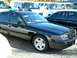 2002 Ford Crown Victoria - Black 2002 Ford Crown Victoria police car with blue light bar, parked outdoors.