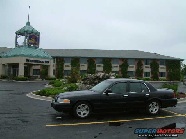 Black 2002 Ford Crown Victoria parked outside a hotel