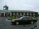 2002 Ford Crown Victoria - A black 2002 Ford Crown Victoria is parked in front of a hotel on a cloudy day.