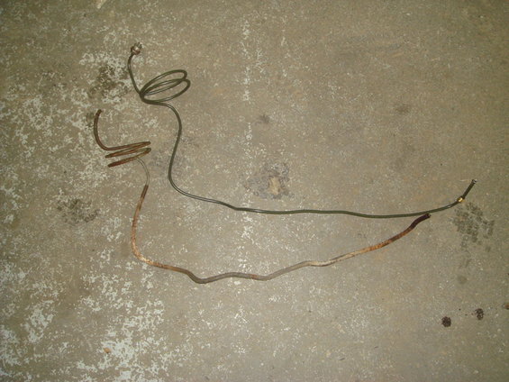 Rusty and green brake line on concrete floor