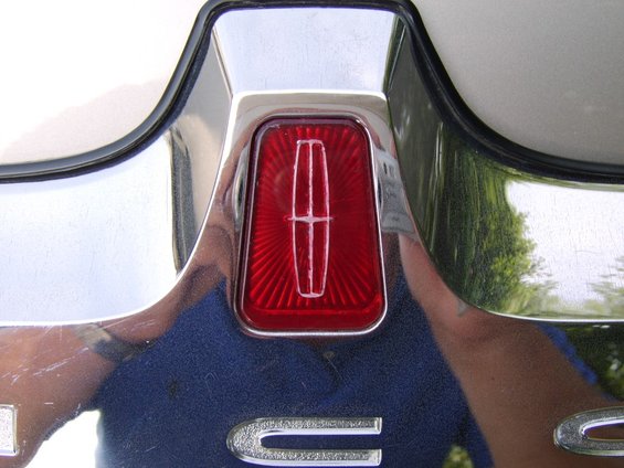 sta70600.jpg After! 

I used candy apple red (transparent) paint on the backside with the shiny chrome behind to achieve the same pearlescent look as the stock red emblem.

It didn't come out anywhere perfect, but it's still MUCH better looking than before.



I did not know the chrome of the Lincoln star was molded and raised into the metal housing BEHIND the lens, which made painting a PITA as I had to mask out the little tiny grooves.
The backside also has flutes grooved in which interlock with flutes i nthe housing behind.

I wont be trying this again, and now that I see how the emblem is constructed - replacement of the whole rear license surround is a better option.