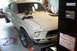 1968 Ford Mustang - This 1968 Ford Mustang coupe is in the process of restoration, with tools and parts visible in the garage setting.