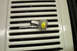 1968 Ford Mustang - A light bulb marked '157' rests on a white slatted grille, possibly a part for a vehicle.