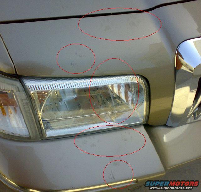 2007 Mercury Grand Marquis front bumper and headlight with scuff marks circled