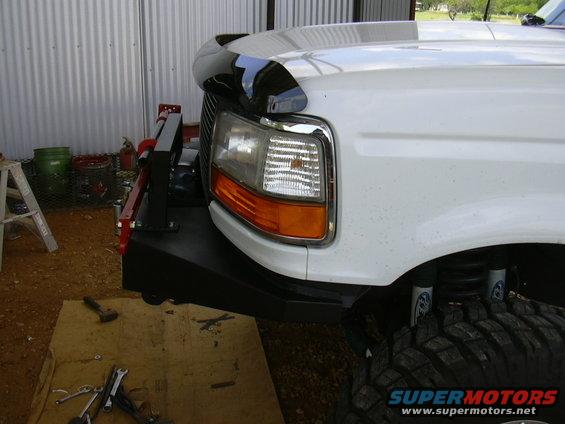 White Ford F-Series truck front fender and custom bumper with large tire