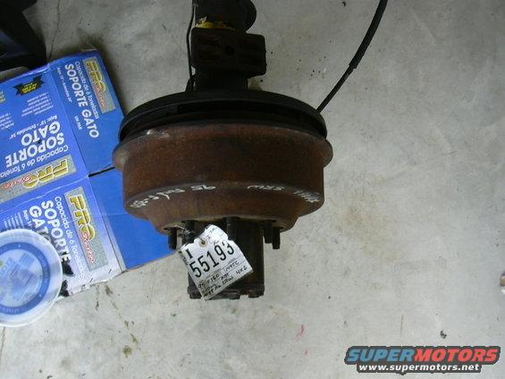Rusty front axle assembly with a white tag labeled 55193