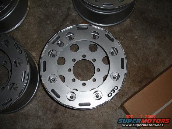Several aftermarket wheels with a multi-hole pattern and cutouts, some with 'CEO' text visible