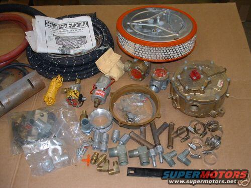 Collection of propane system parts: air cleaner, hoses, regulators, fittings