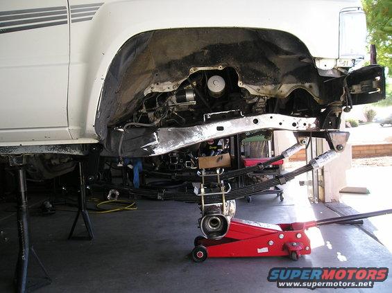 1986 Toyota Hilux front suspension disassembled with leaf springs and jack