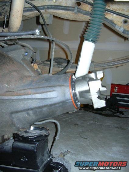 Close-up of a vehicle's rear axle housing with a shock absorber attached