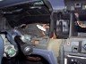 Interior shot of a car's dashboard, showing the steering wheel and center console area