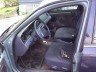 Interior of a dark-colored car, showing the driver's seat, steering wheel, and dashboard