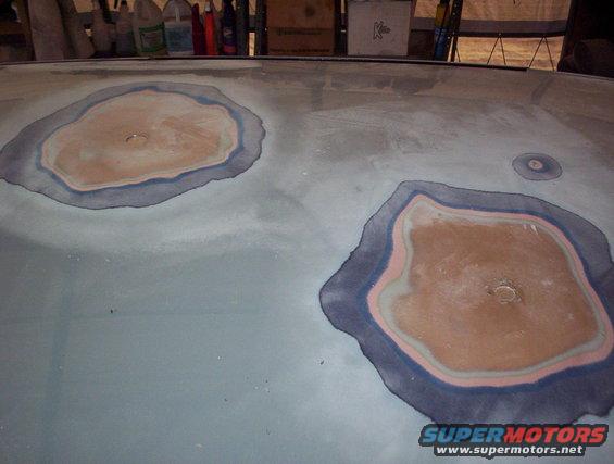 Car hood with two large body filler patches and a smaller one